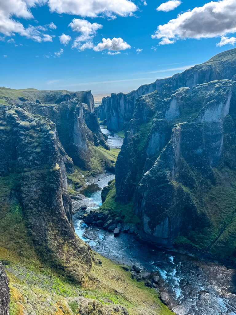 A river flows between two canyon walls in Iceland.