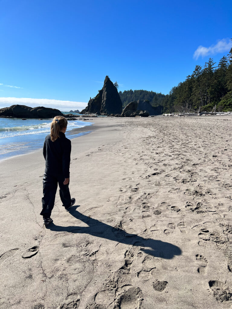 A young girl tackles one of the more difficult Olympic National Park hikes for families, the black sand beach on the way to the Hole-In-The-Wall.