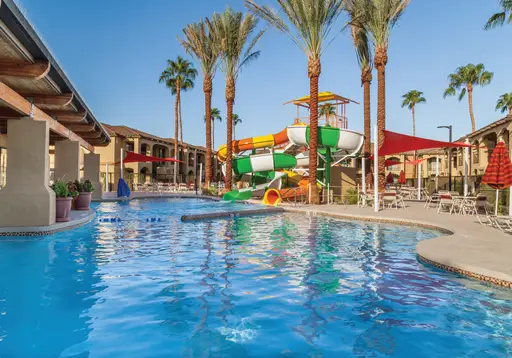 Water slides twisting into an empty pool.