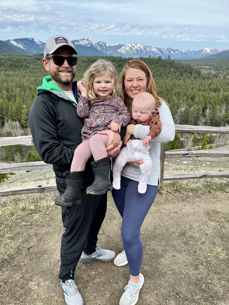 Meet Megan, a family and leisure travel agent, who loves traveling with her family. This photo is of her and her two young daughters in front of the mountains.