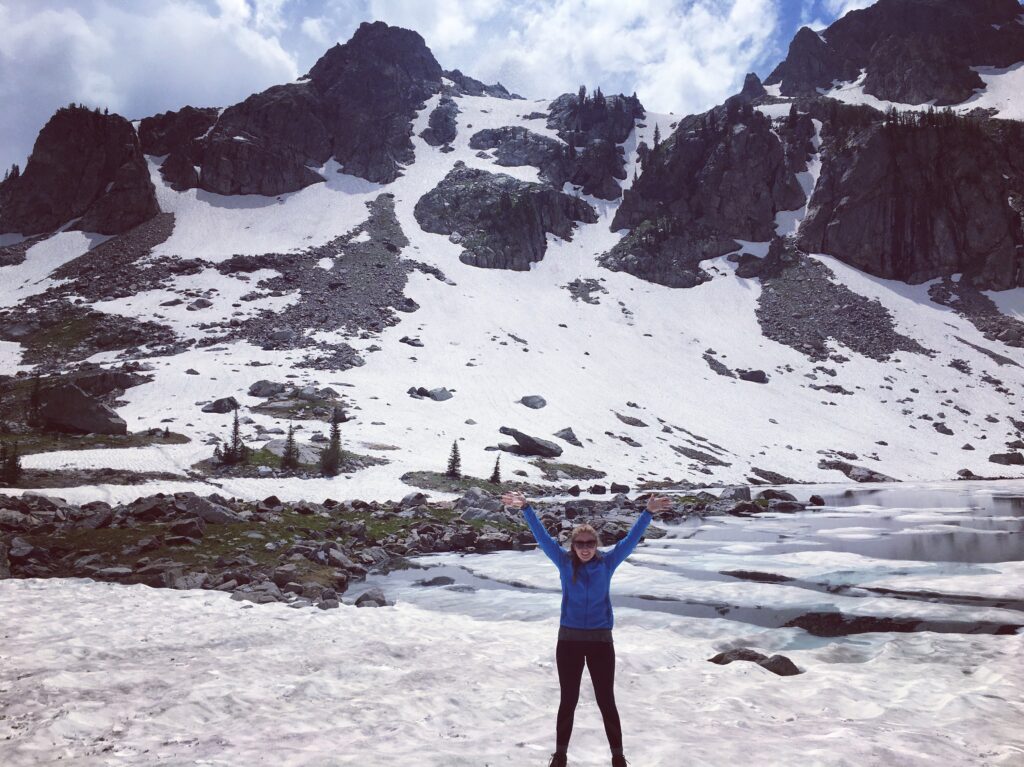 Megan, a family and leisure travel agent, on a snowy mountain top.