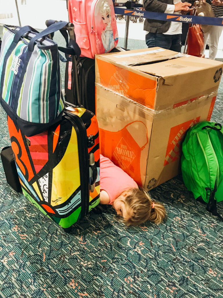 Worried about what to wear to Disney World in March? We packed all the right stuff in our suitcases. Including a grumpy toddler laying on the ground of the airport.