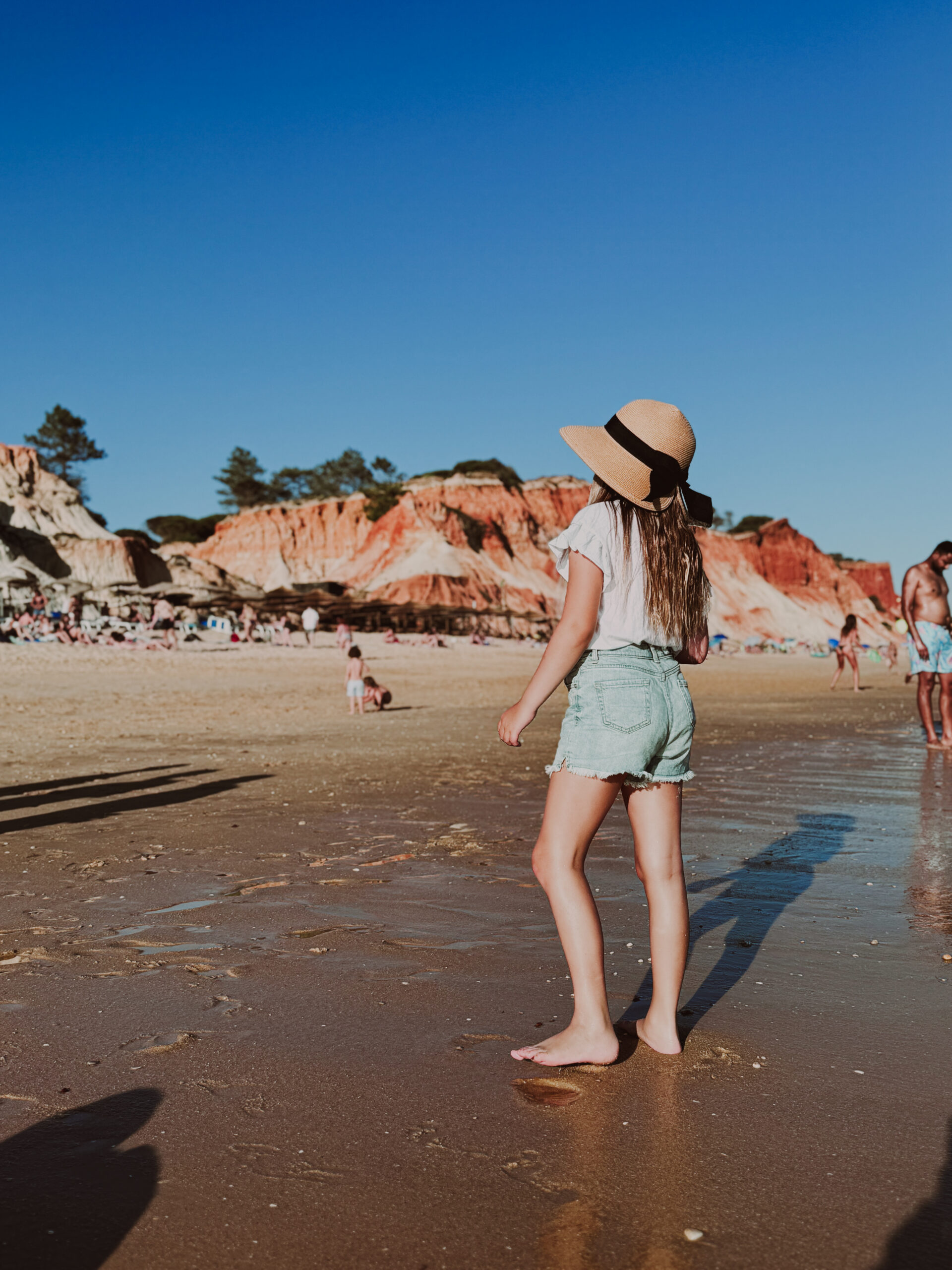 a young girl looking at the cliffs on Falesfi beach